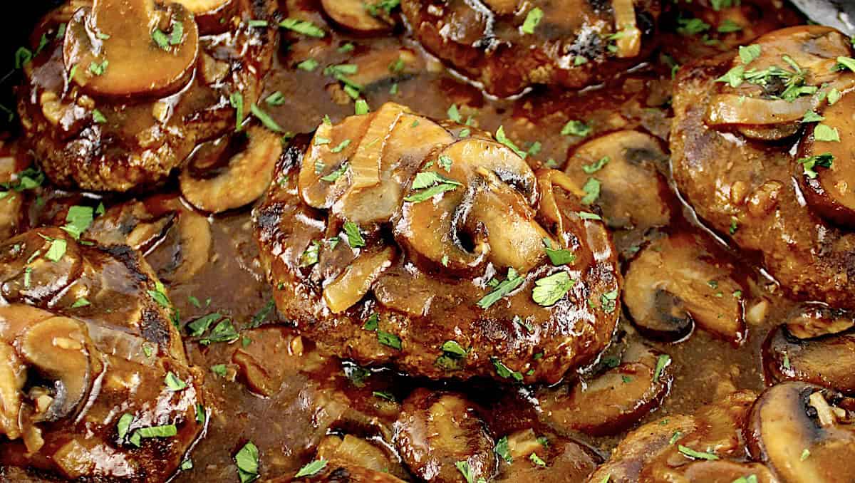 closeup of Salisbury Steak with mushroom gravy in skillet