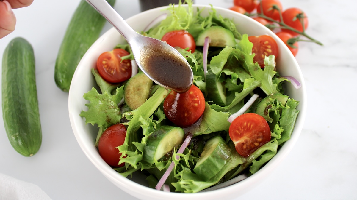 Balsamic Vinaigrette being spooned over salad