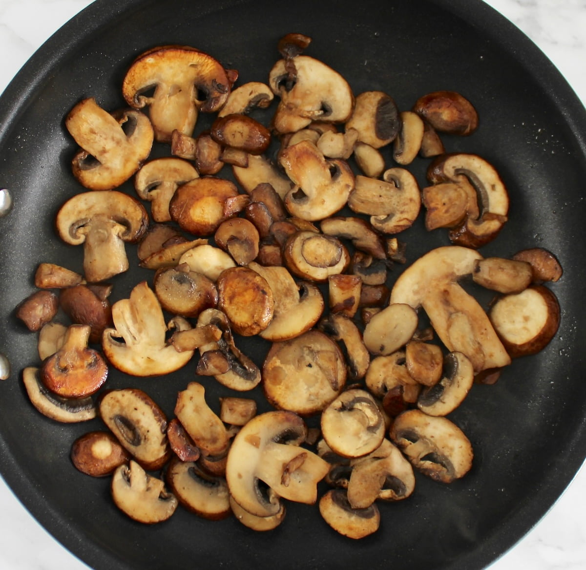 sautéed sliced mushrooms in skillet
