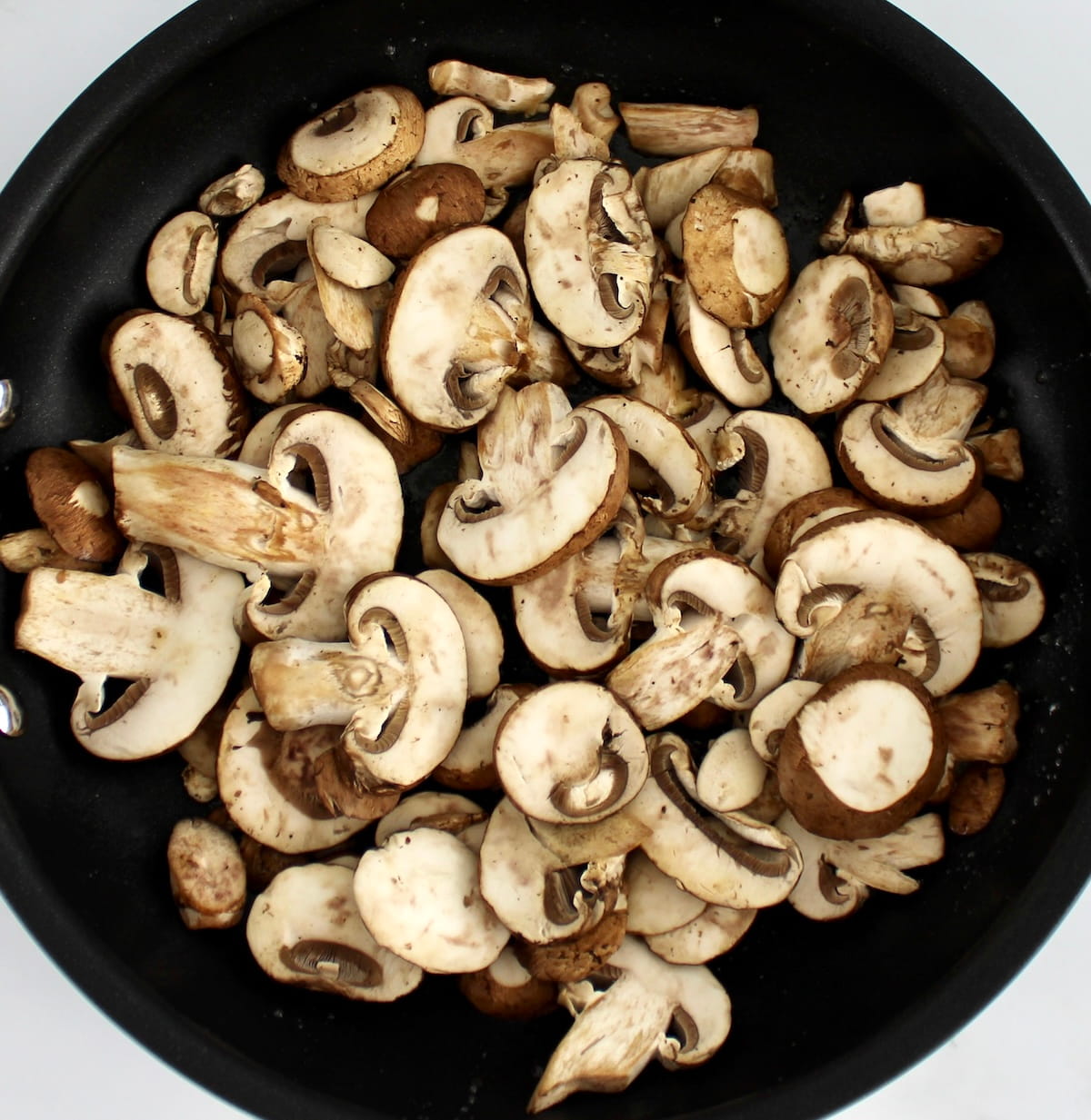 raw mushrooms in skillet