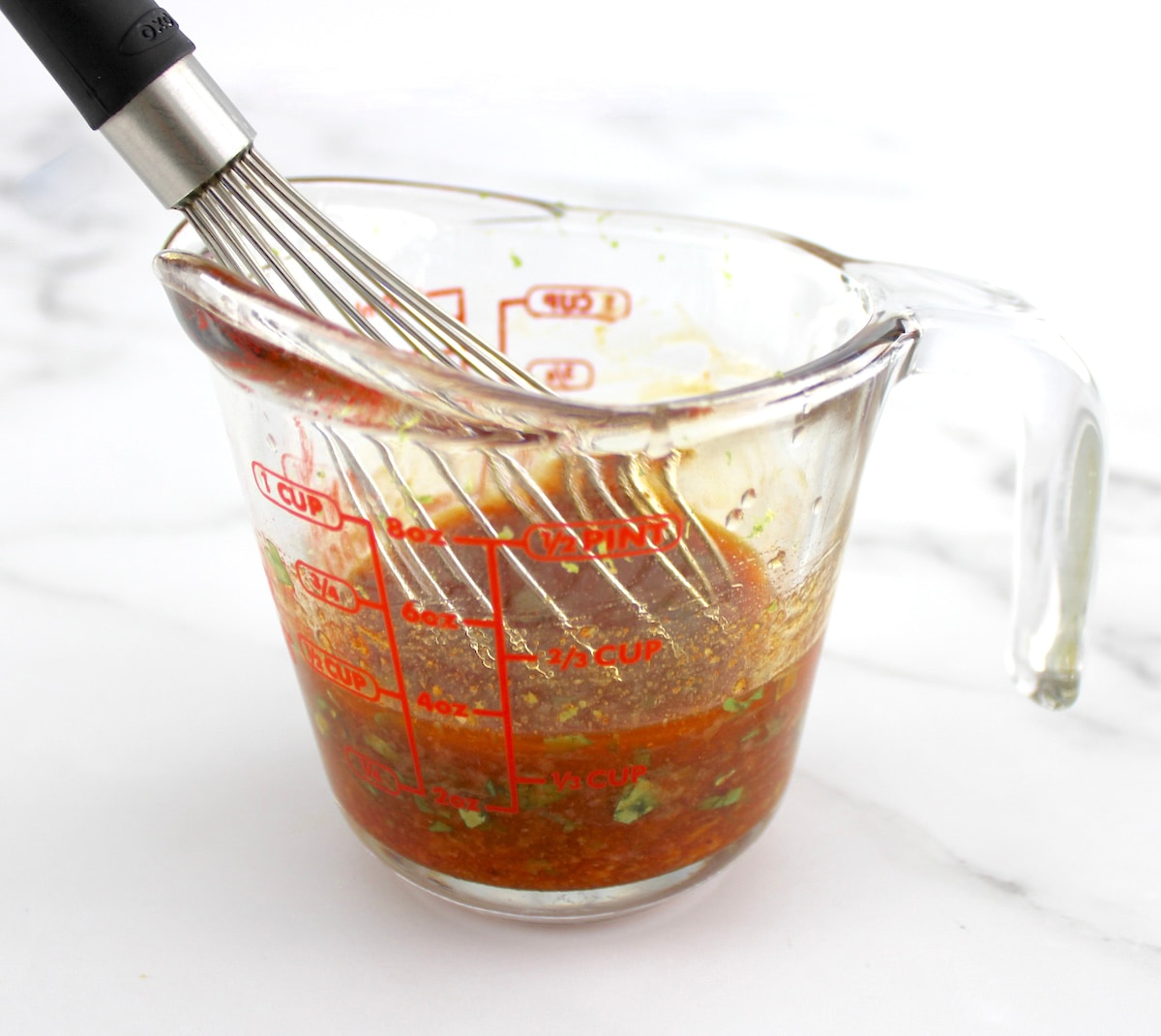 lime cilantro marinade in measuring cup with whisk