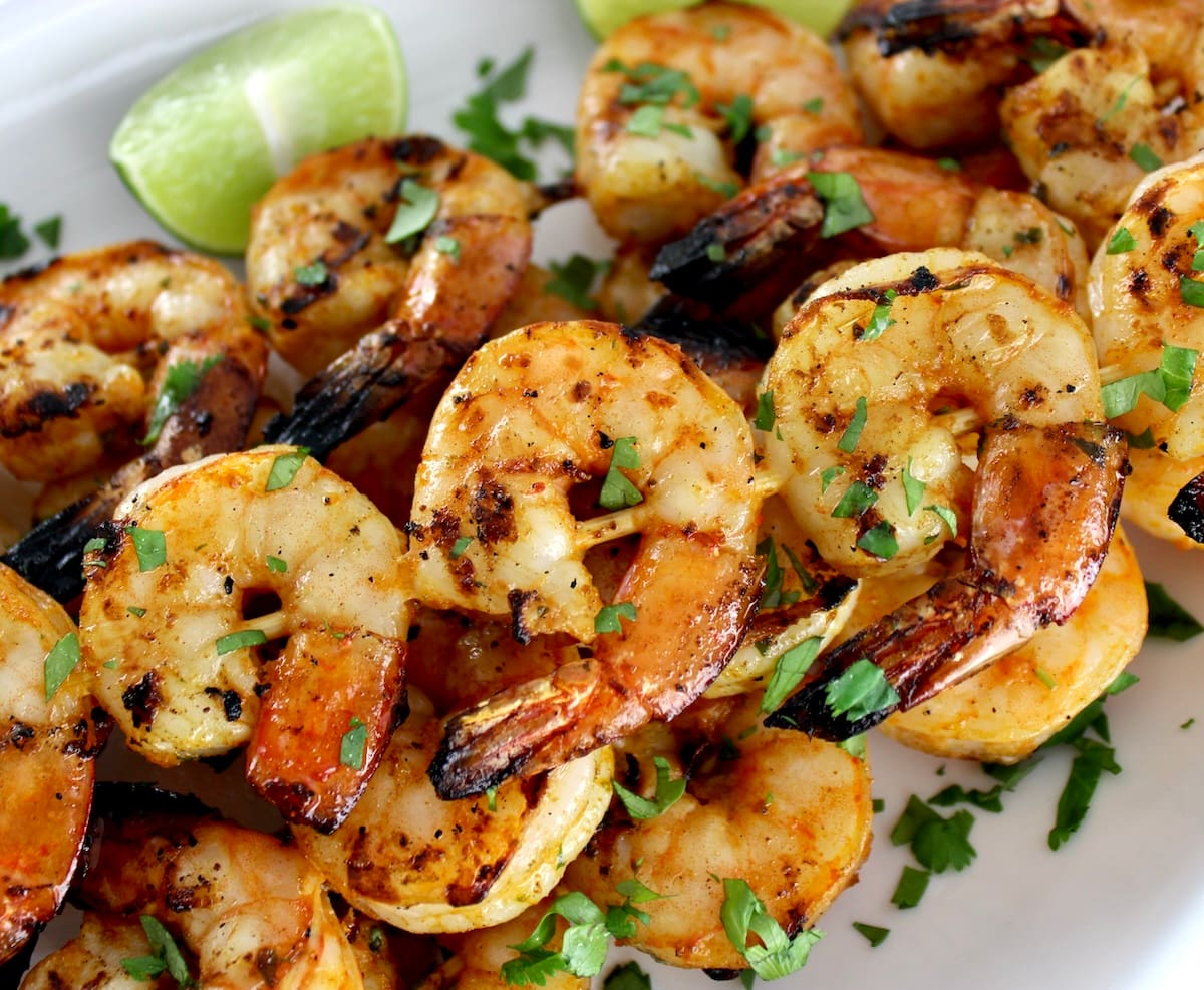 closeup of Grilled Lime Cilantro Shrimp Skewers on white plate