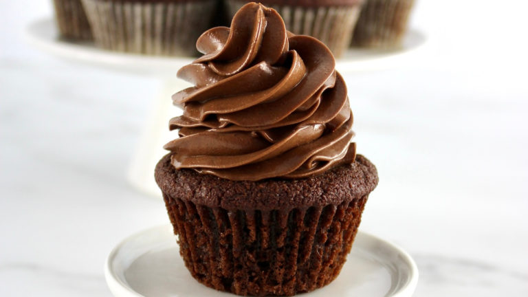 closeup side view of Keto Chocolate Cupcake on round white plate