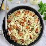 Keto Shrimp Alfredo in skillet with serving spoon