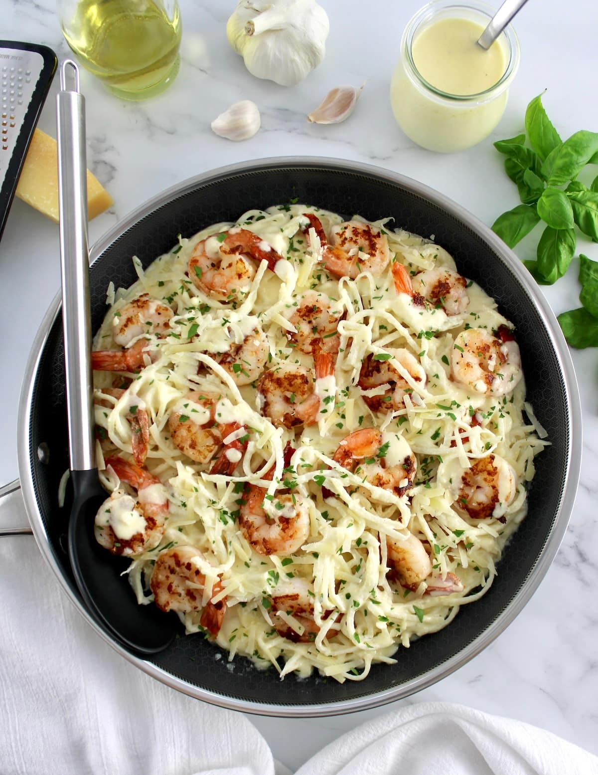 Keto Shrimp Alfredo in skillet with serving spoon