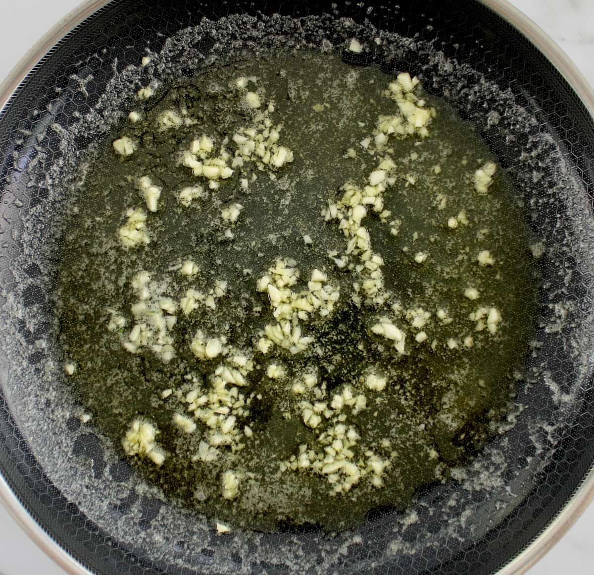 minced garlic and melted butter in saucepan