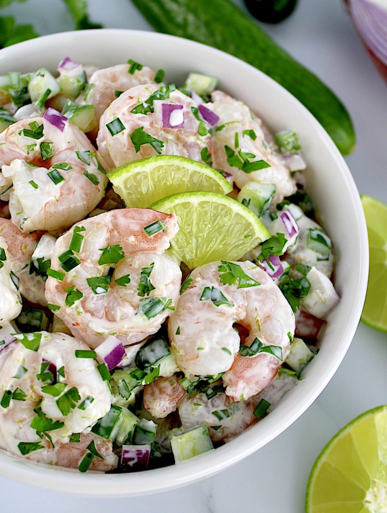 Lime Cilantro Shrimp Salad in white bowl with 2 lime slices
