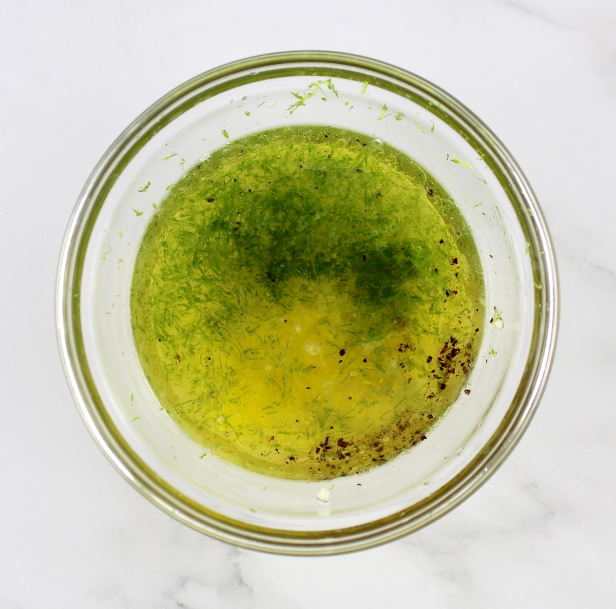 Avocado Salsa dressing ingredients in glass bowl unmixed