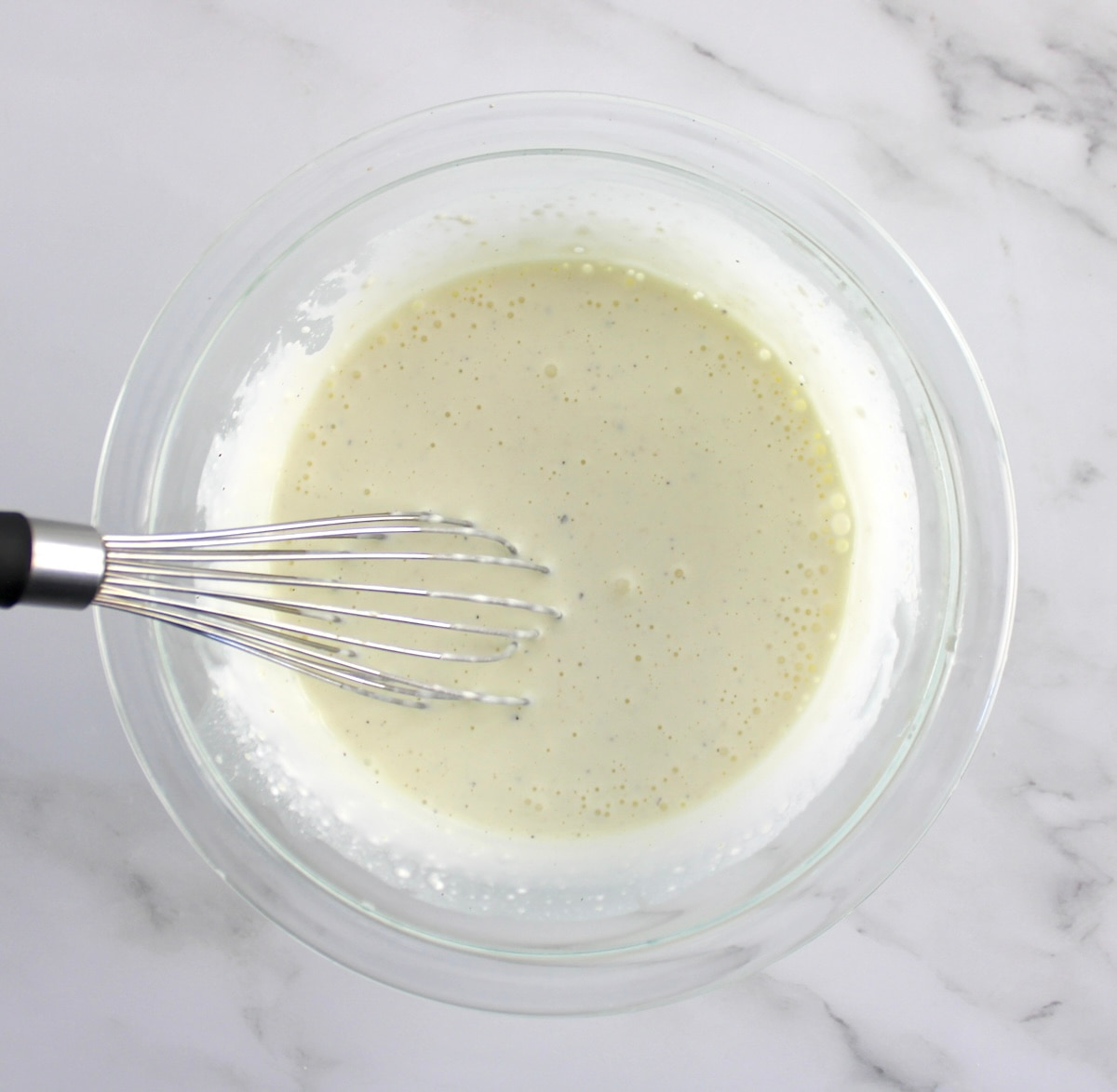 Dill Pickle Coleslaw in glass bowl with whisk