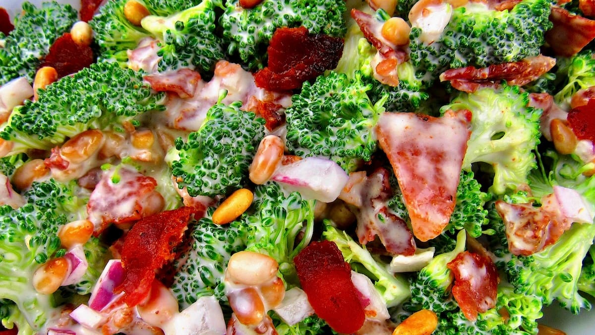 closeup of broccoli salad in white bowl