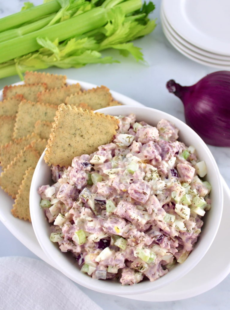 Ham Salad in white bowl with cracker in and on the side