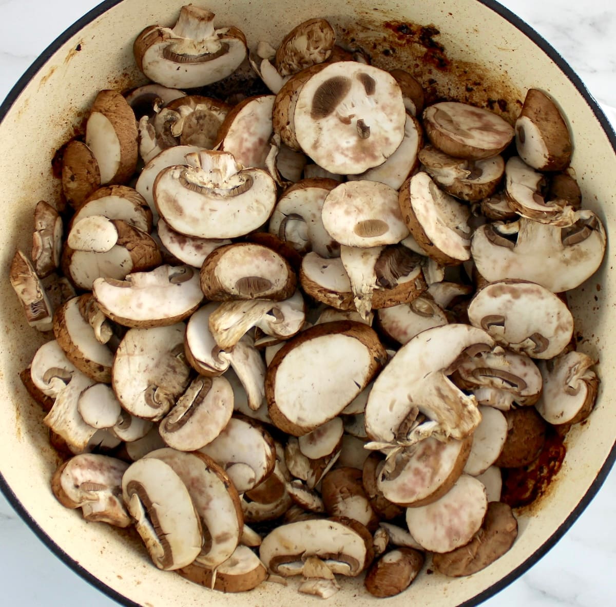 raw mushrooms in skillet