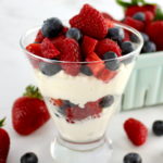 Keto Berries and Cream layered in glass with berries on top and on side