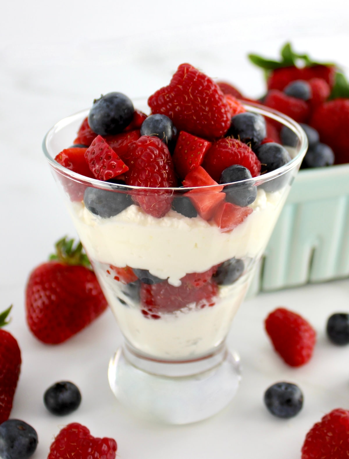 Keto Berries and Cream layered in glass with berries on top and on side