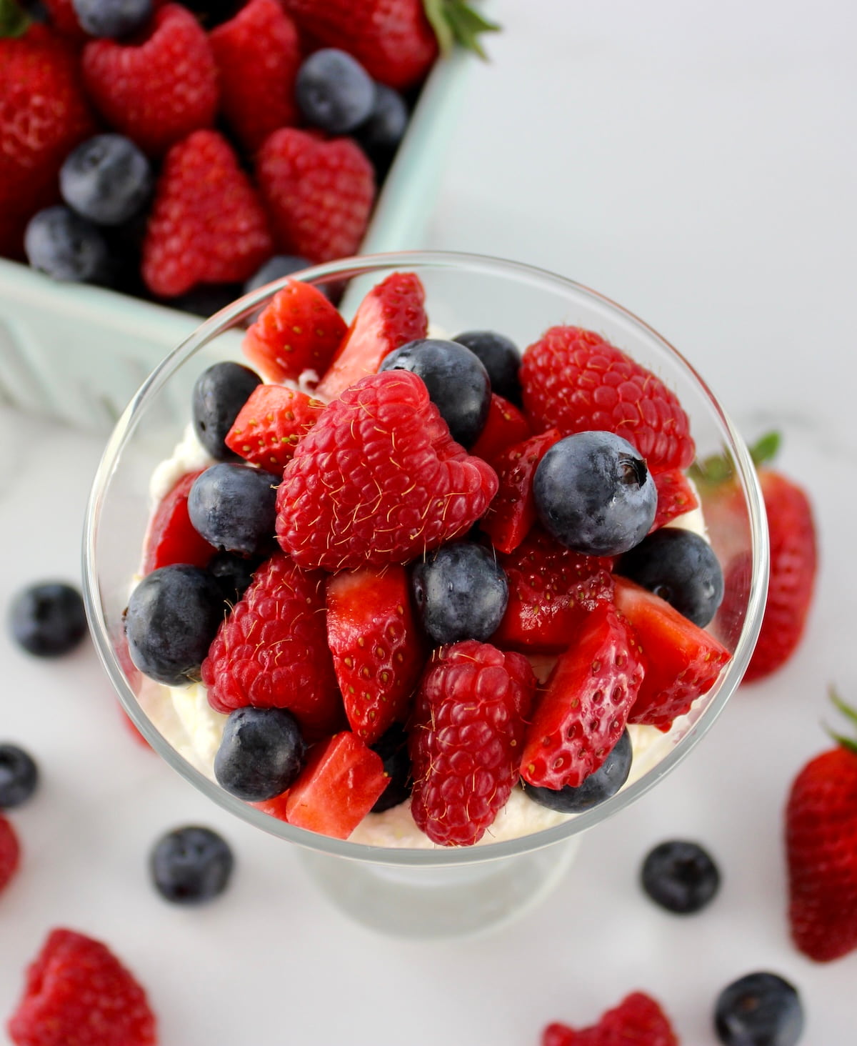 overhead view of Keto Berries and Cream in glass with berries on top and in back