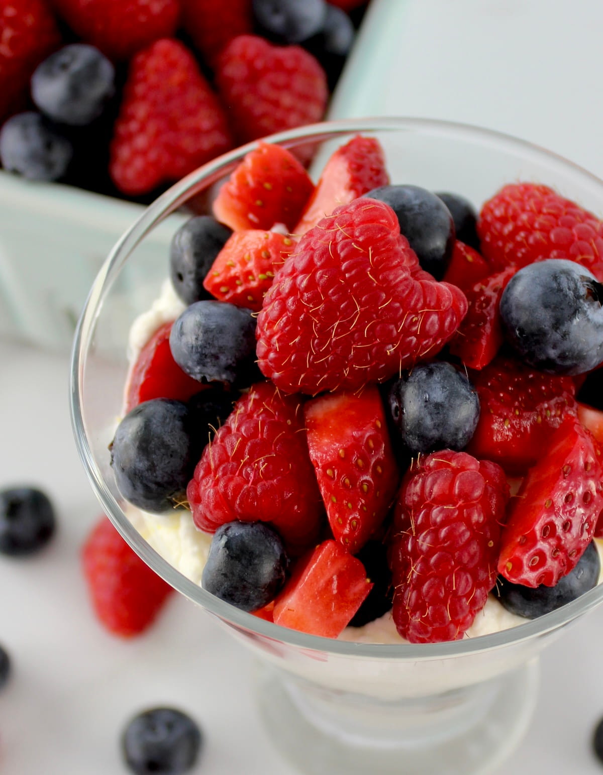 overhead view of Keto Berries and Cream in glass with berries on top and in back