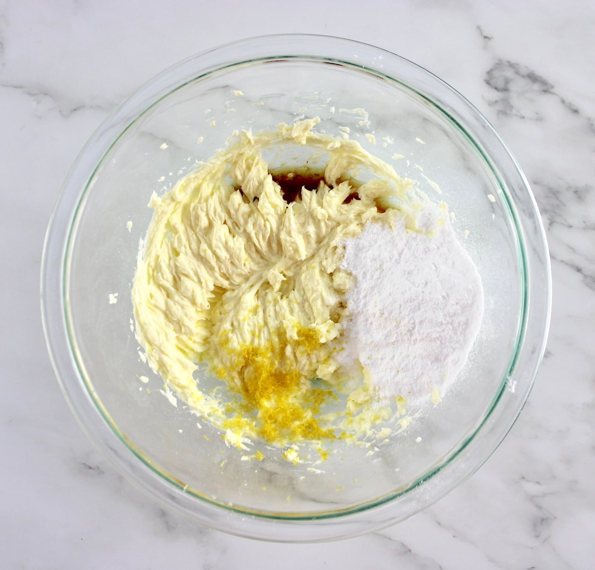 whipped mascarpone cheese, sweetener, lemon zest and vanilla in glass bowl unmixed