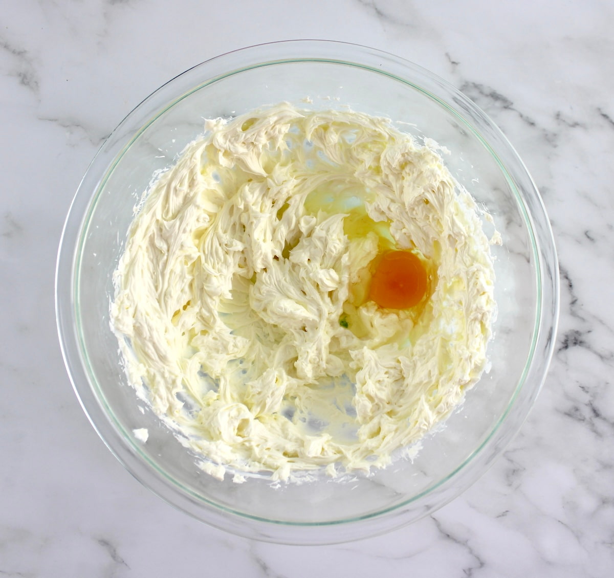 whipped cream cheese and 1 egg in mixing bowl