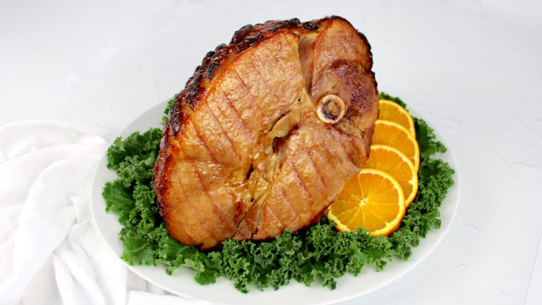 Keto Glazed Ham on platter with kale and sliced oranges