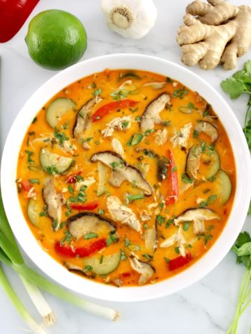 overhead view of Thai Coconut Curry Chicken Soup in white bowl