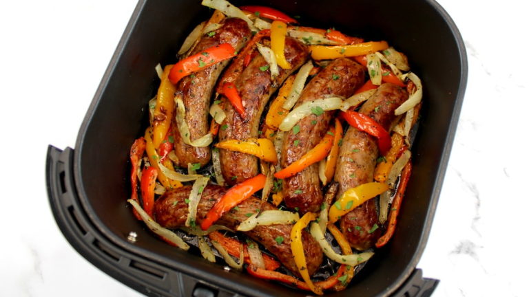 closeup of Air Fryer Sausage, orange and red Peppers, with onions