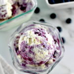 overhead view of Blueberry Vanilla Swirl Ice Cream in glass with blueberries in back
