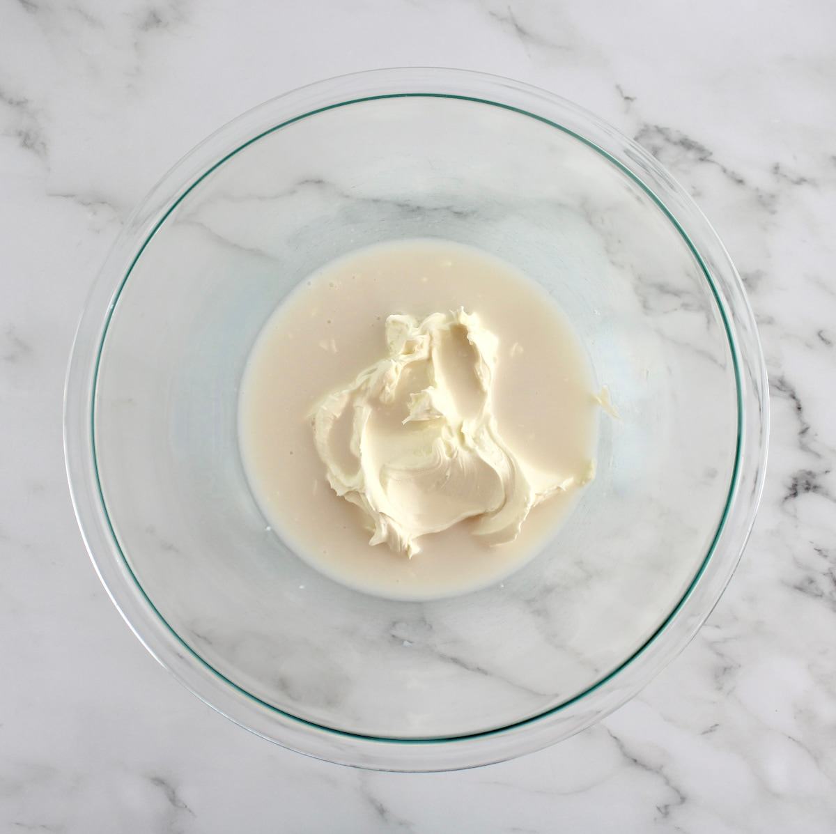 mascarpone cheese and almond milk in glass bowl unmixed