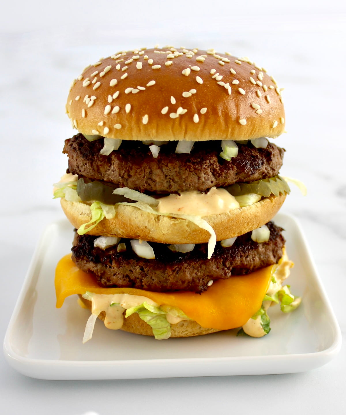 closeup side view of Keto Big Mac on white plate