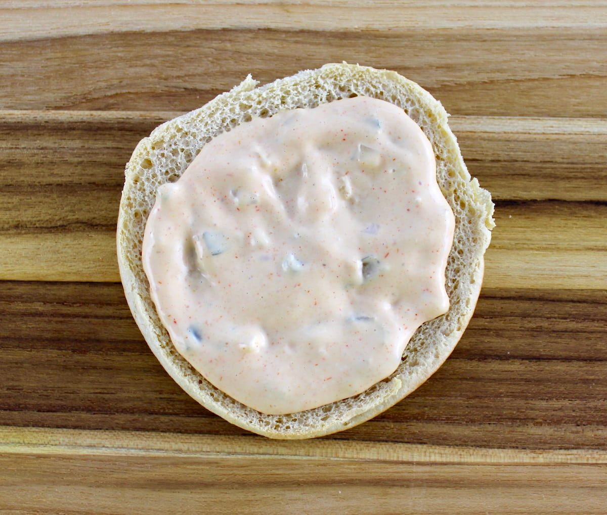 bottom hamburger bun with big mac sauce on top