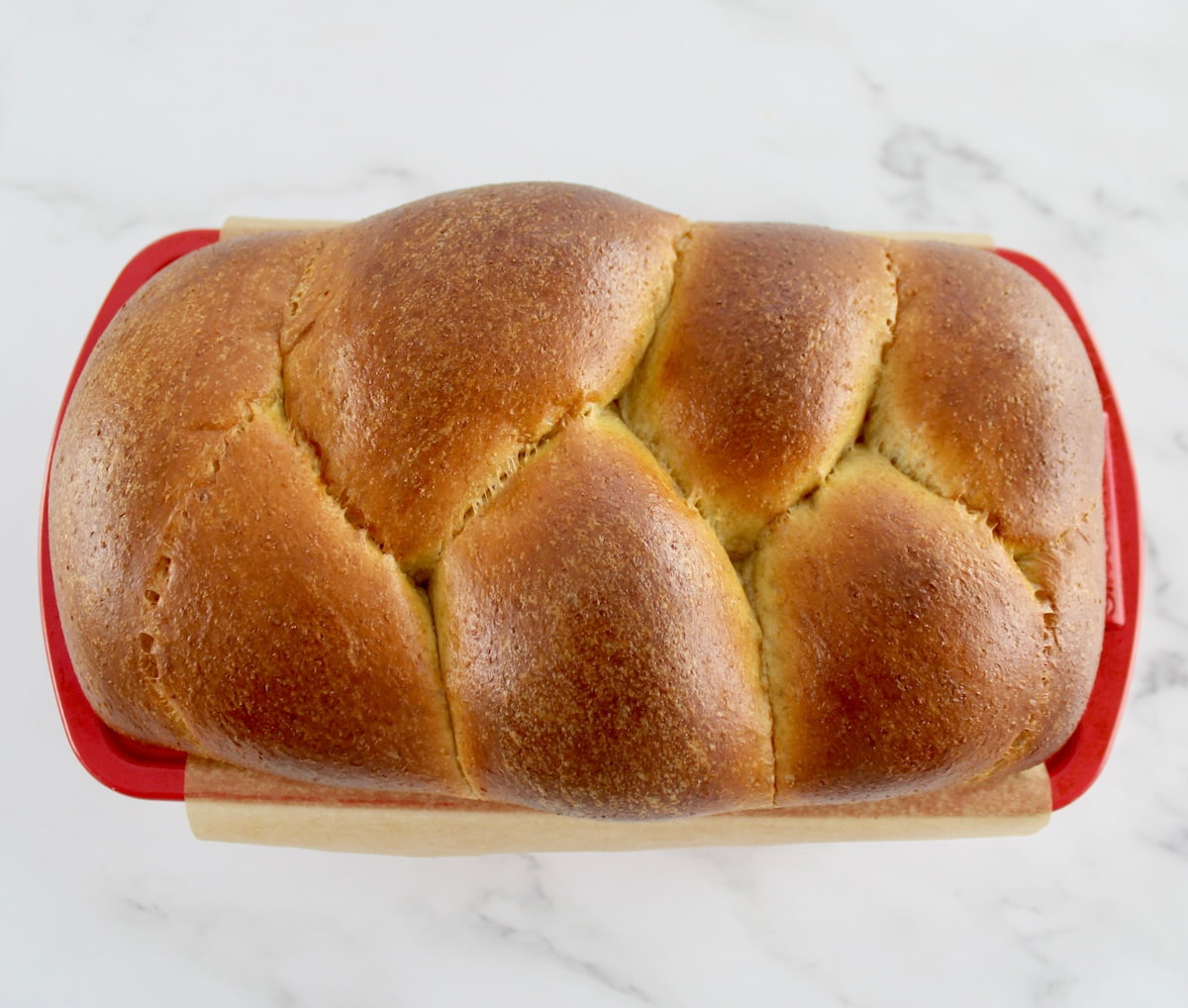 baked Keto Brioche Bread in red loaf pan