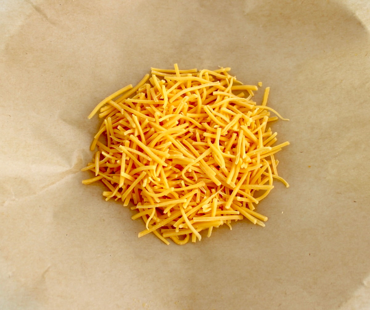 shredded cheese on parchment paper