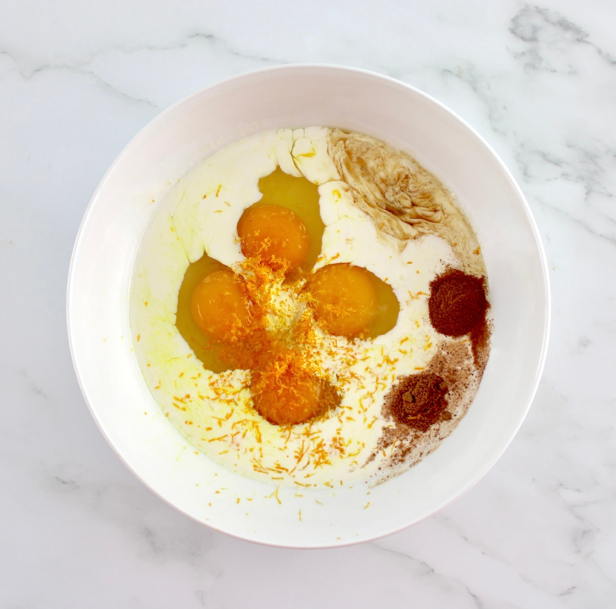 french toast egg mixture in white bowl unmixed
