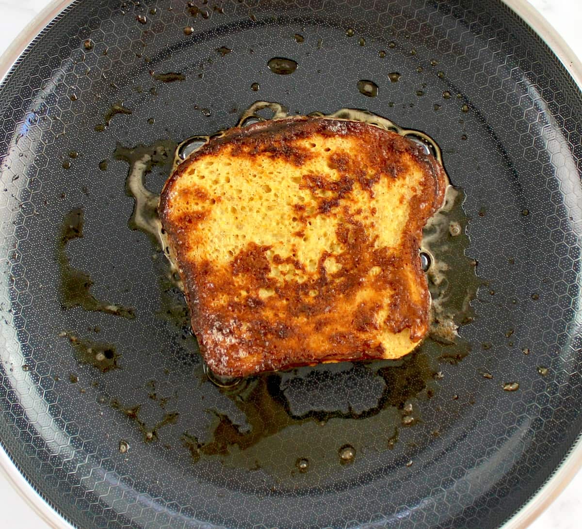 fresh toast in skillet cooking in butter