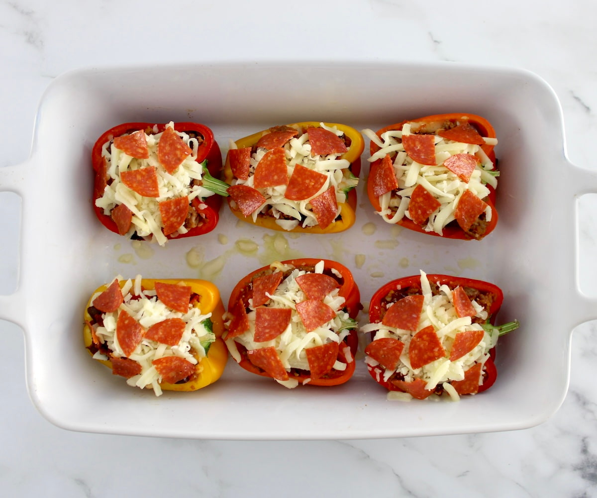 Pizza Stuffed Peppers unbaked in white casserole dish