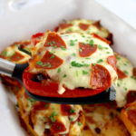 spatula holding up Pizza Stuffed Pepper over casserole