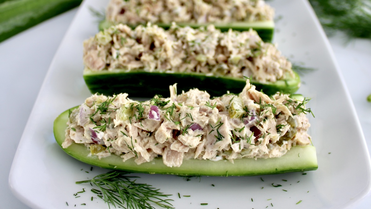 closeup of Dill Pickle Tuna Cucumber Boats on white plate with fresh dill