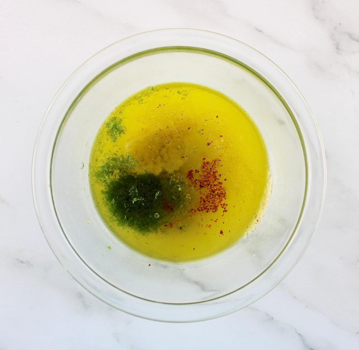 Grilled Tajin Chicken marinade ingredients in glass bowl unmixed