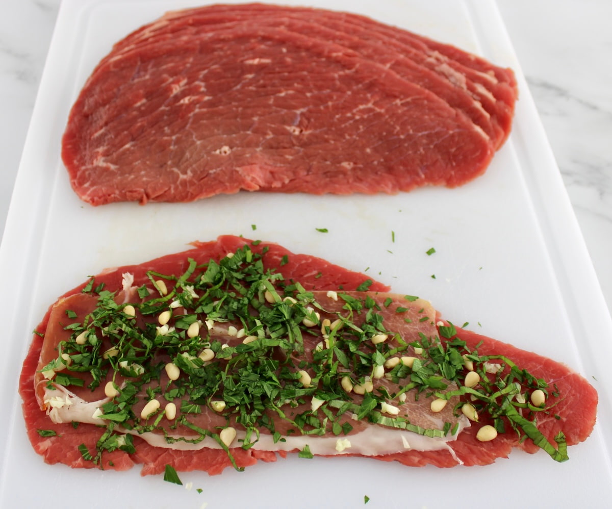 Italian Beef Braciole uncooked on white cutting board