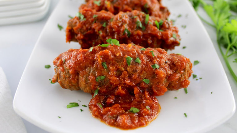 closeup of Italian Beef Braciole on white plate