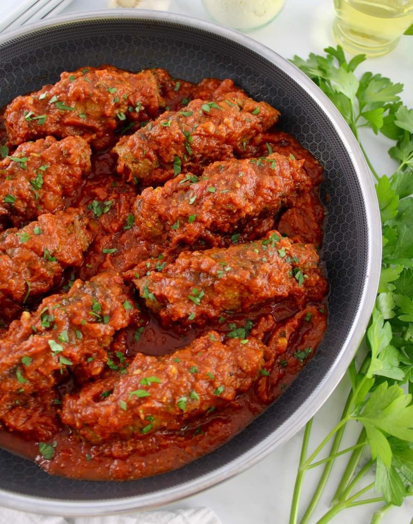 Italian Beef Braciole in skillet in tomato sauce