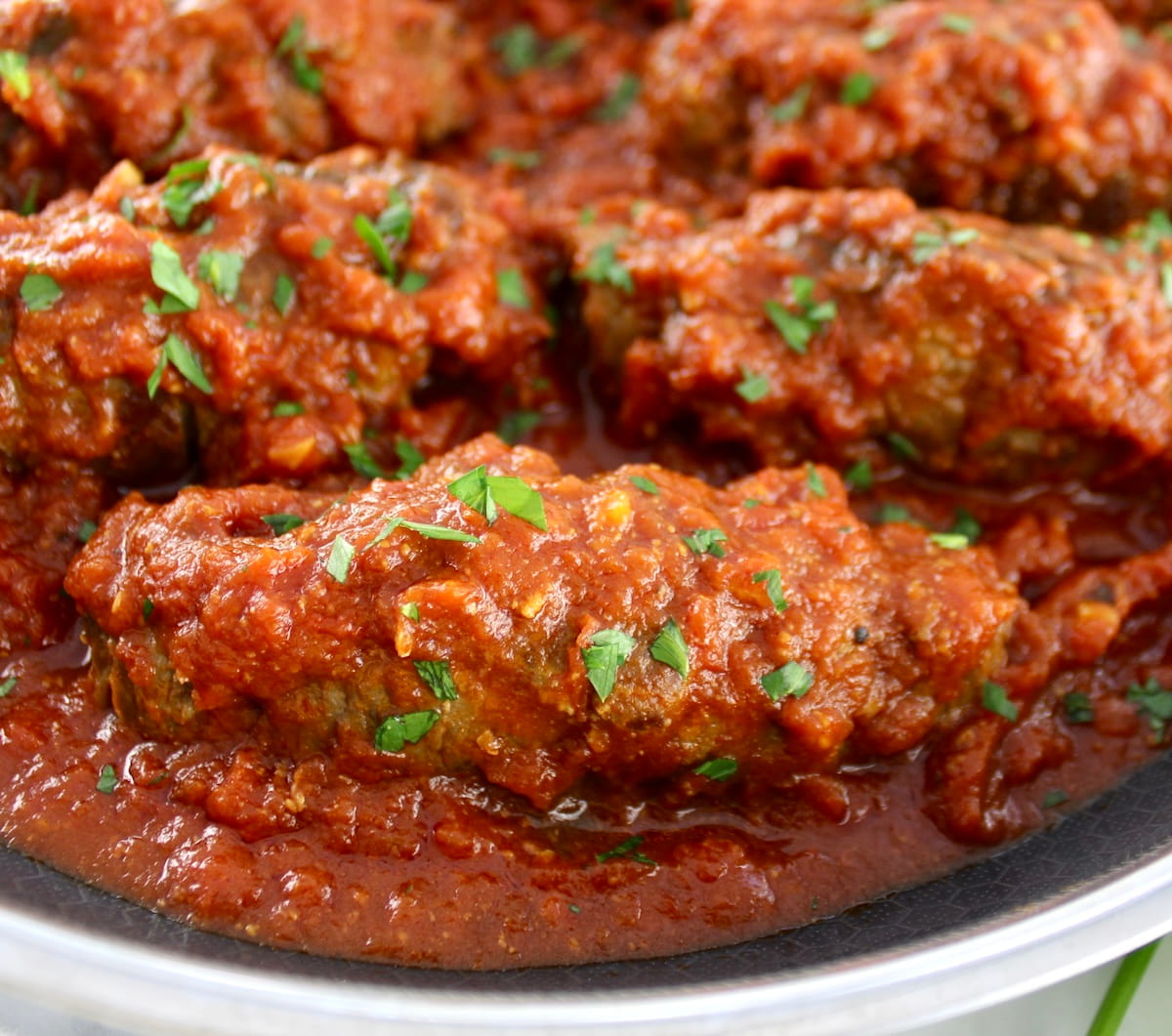closeup of Italian Beef Braciole in skillet in tomato sauce