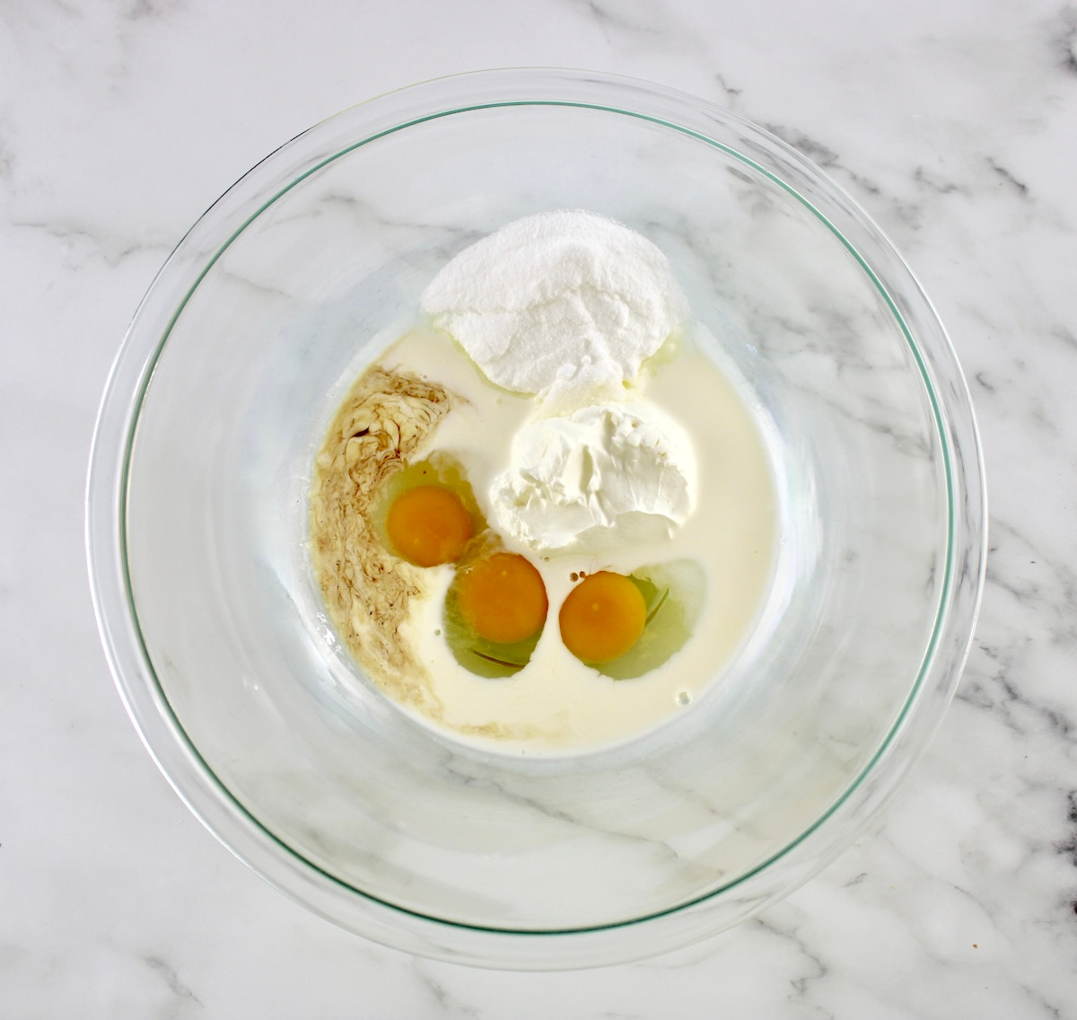 wet ingredients for Keto Coffee Cake in glass bowl unmixed