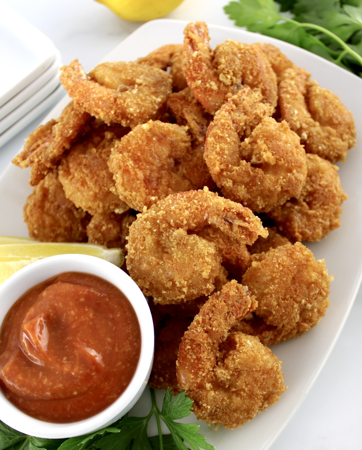 closeup of Keto Fried Shrimp with Cocktail Sauce in white bowl