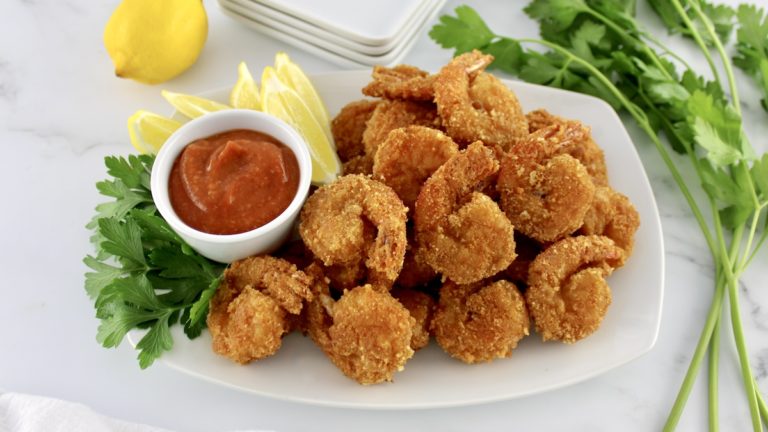 Keto Fried Shrimp with Cocktail Sauce on white dish with lemon and parsley on side