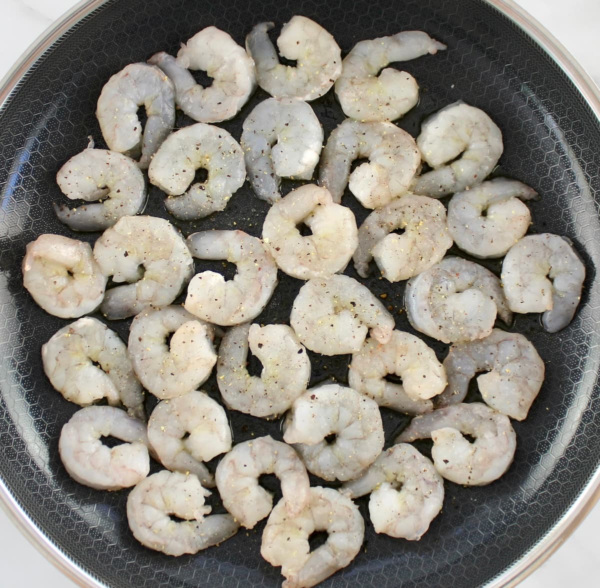 raw shrimp in skillet