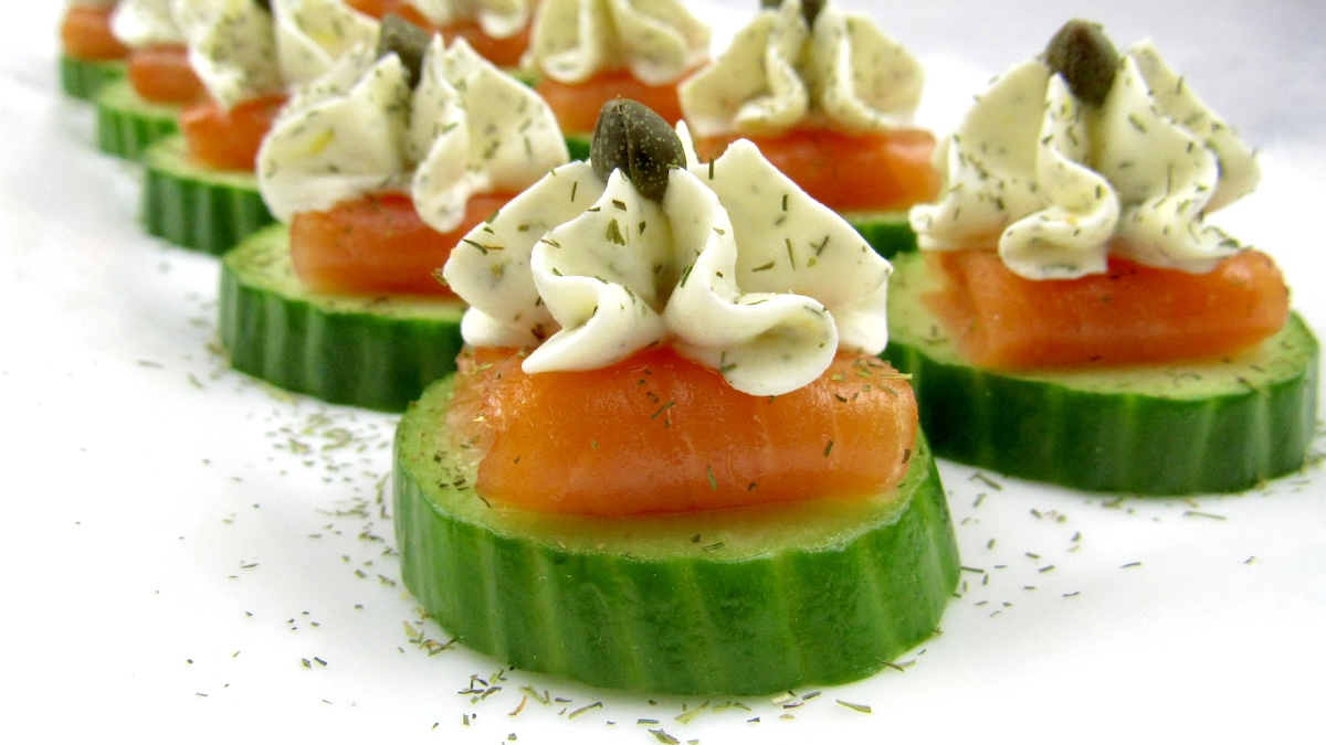closeup of Smoked Salmon Cucumber Bites on white platter