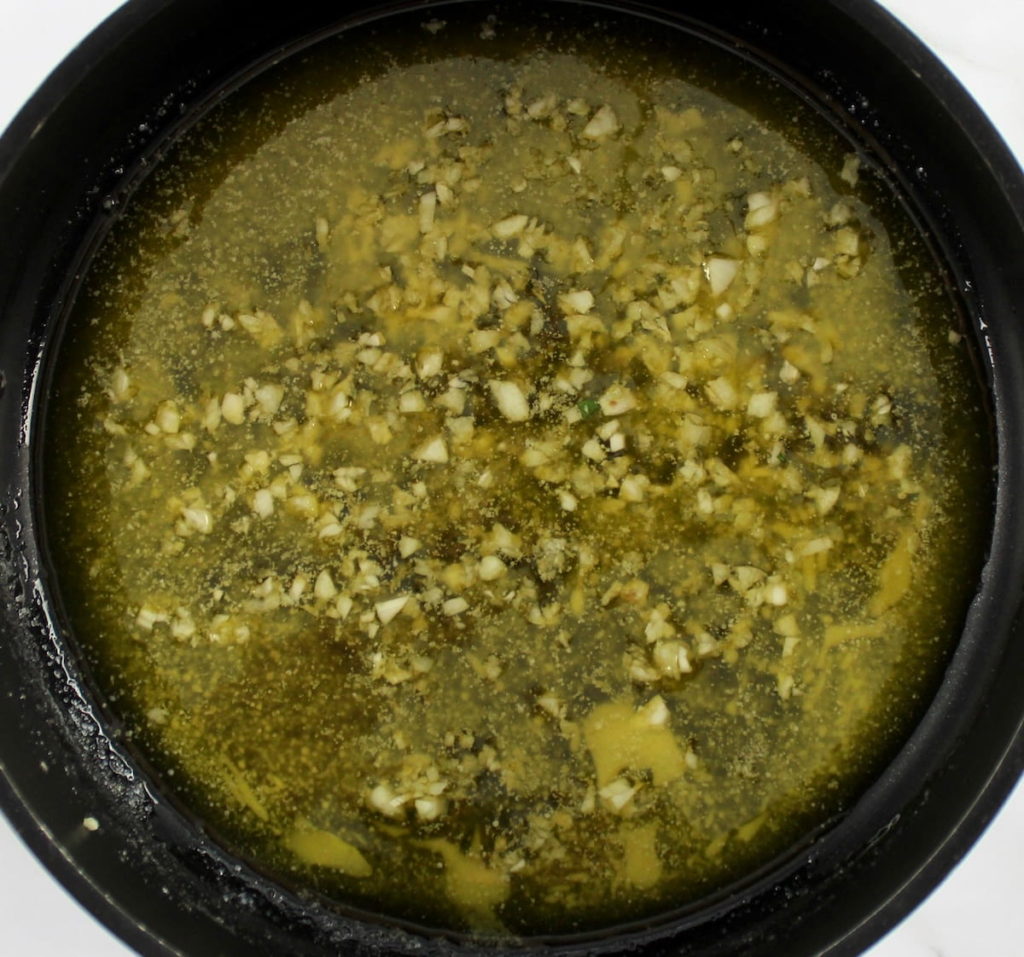 minced garlic cooking in melted butter in sauce pan