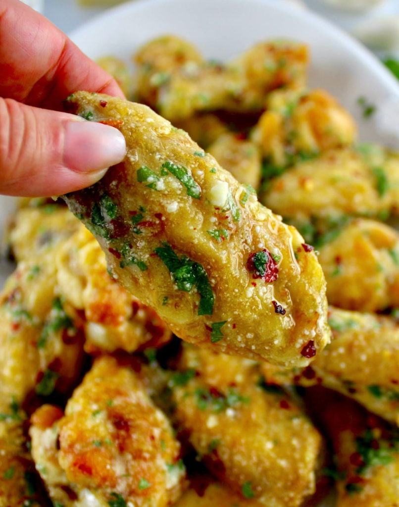 holding up Air Fryer Garlic Parmesan Wing