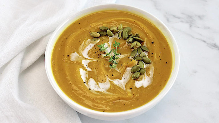 creamy butternut squash in a white soup bowl