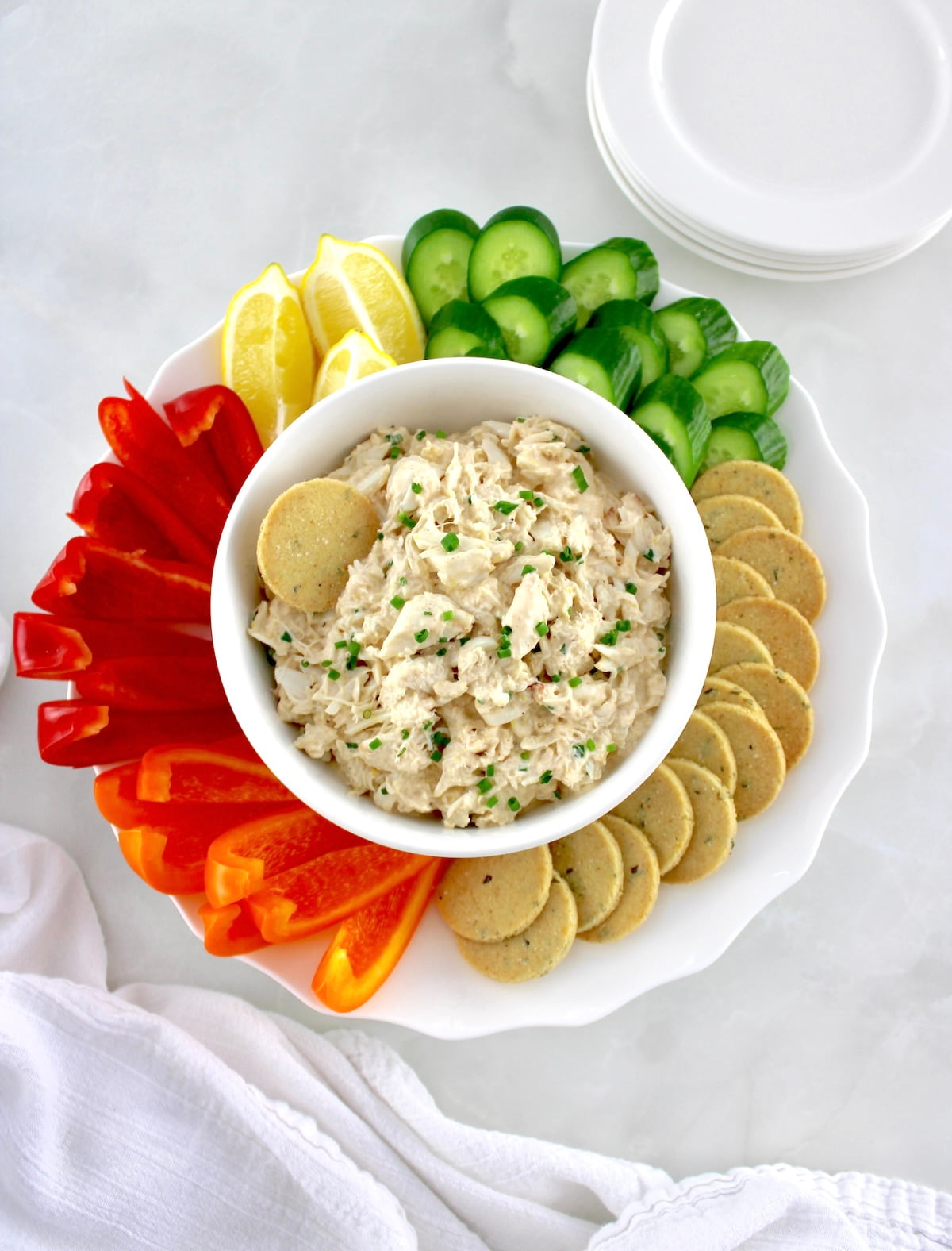 overhead view of Cold Crab Dip in white bowl with fresh raw veggies and crackers around